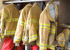 Firefighter Jackets And Helmets On A Rack