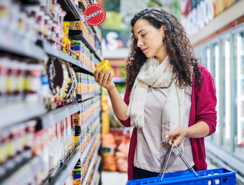 Women In Store Aisle Shopping For A Product.