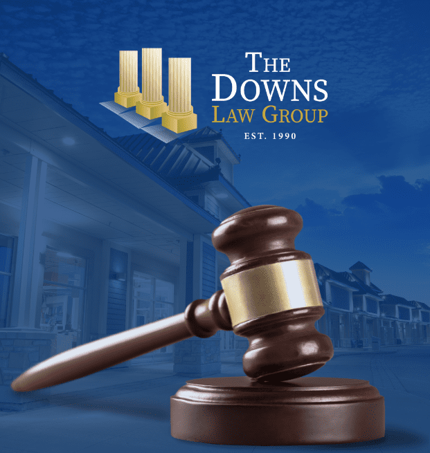 Image Of Commercial Mall Property With A Gavel In Front And A Logo Reading 'The Downs Law Group'