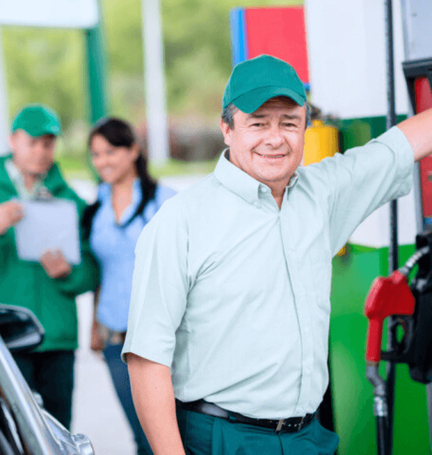 Gas Worker At Gas Station Helping Customers