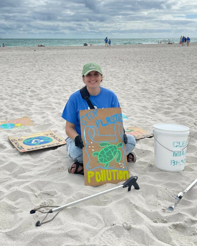 Image of attorney Rachel Martin as a Clean Miami Beach clean-up volunteers for event sponsored by The Downs Law Group titled "I Love The Ocean"