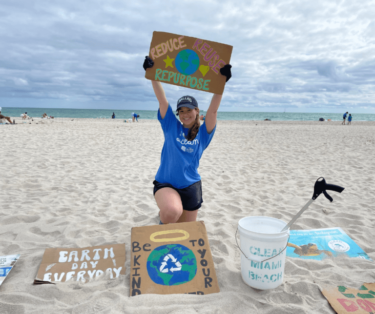 Image of Chelsea Echeverria with Clean Miami Beach clean-up volunteers for event sponsored by The Downs Law Group titled "I Love The Ocean"