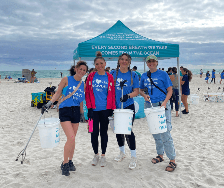 Image of all Downs Law Group employees, Jordana Arauz, Rachel Martin, Esq., and Dorothy Harrison with Clean Miami Beach clean-up volunteers for event sponsored by The Downs Law Group titled "I Love The Ocean"