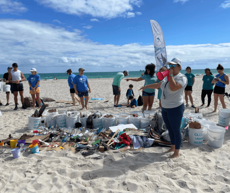 Image of all trash cleaned off beach during Clean Miami Beach clean-up volunteers for event sponsored by The Downs Law Group titled "I Love The Ocean"
