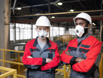A Couple Of Workers Wearing Masks And Helmets
