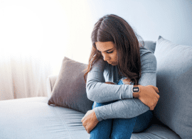 Veteran Women With Mental Health Issues Sitting On Bed Upset Due To Ptsd